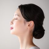 目を閉じる横顔の女性