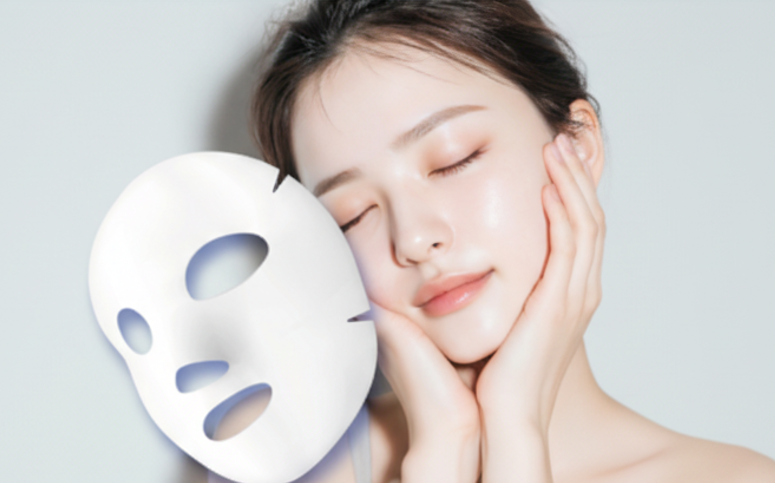 フェイスパックと頬に手をあてる女性